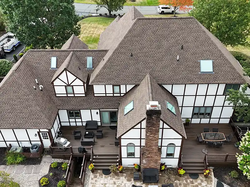 Large home with new GAF Barkwood shingles installed on its roof