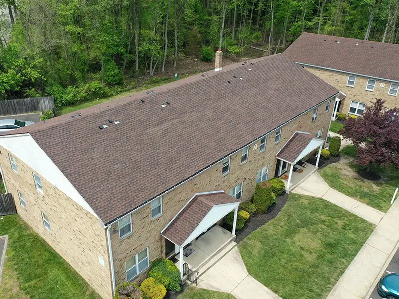 Small multifamily home with new GAF shingles installed on its roof