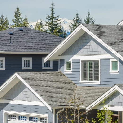 New asphalt shingles on blue colored residential home