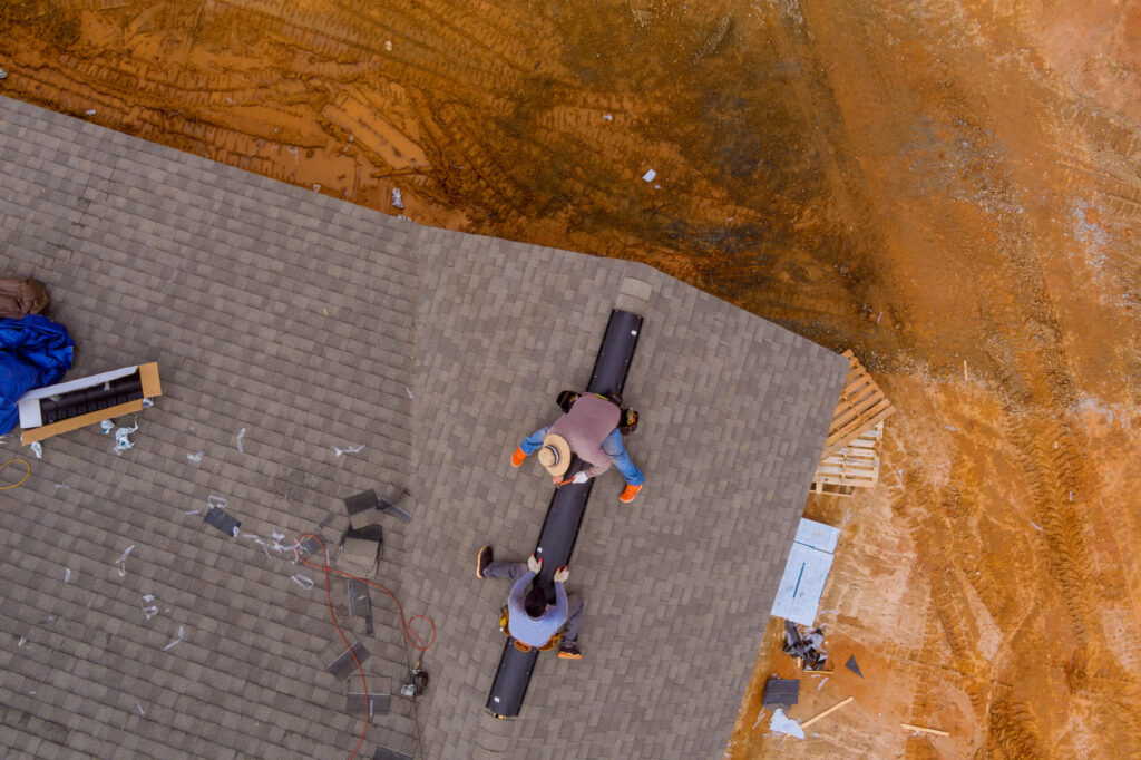 Top-down image of roofers installing a new roof.